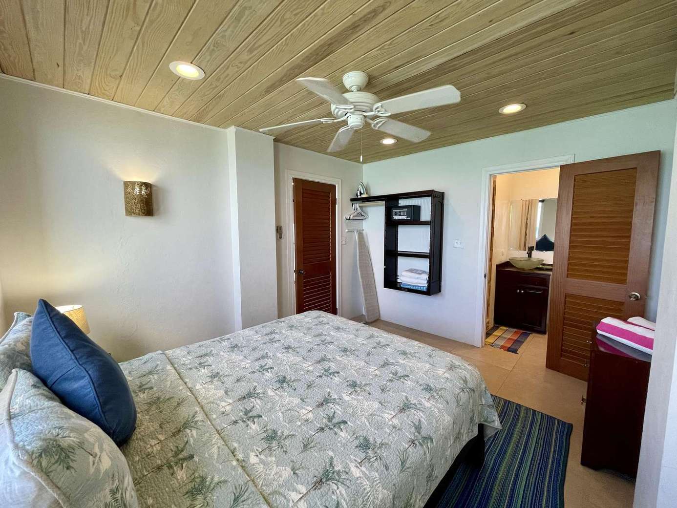 Cozy bedroom retreat with calming natural tones and ceiling fan