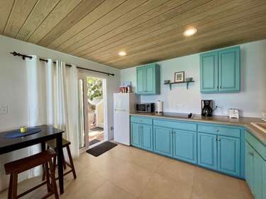 Bright kitchen with turquoise cabinets and cozy dining nook