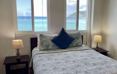Cozy bedroom with stunning ocean views and natural light