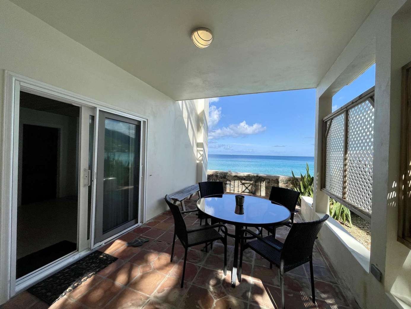 Ocean-view balcony with cozy dining for sunset meals