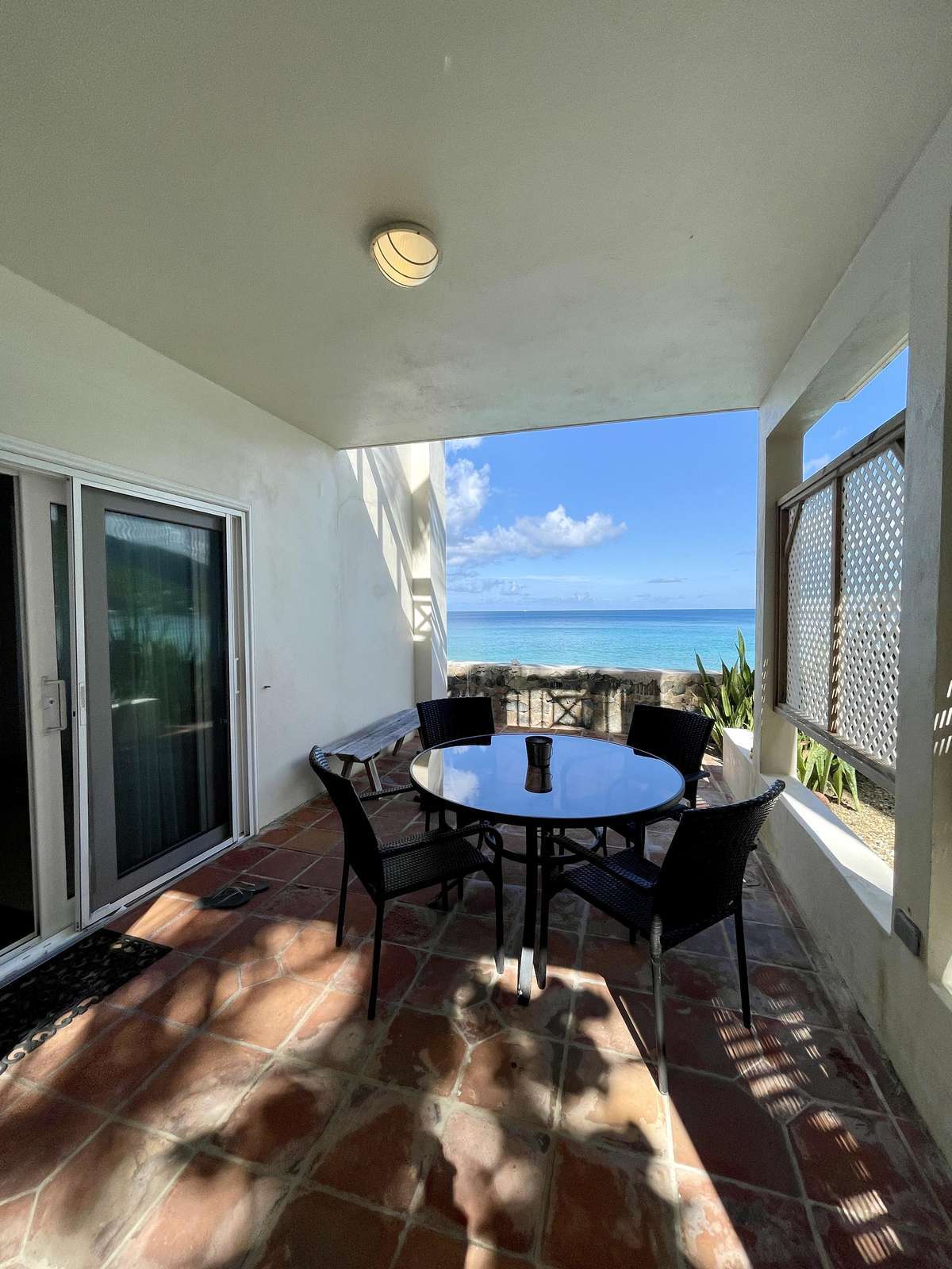 Sunlit patio with stunning ocean views for relaxing meals
