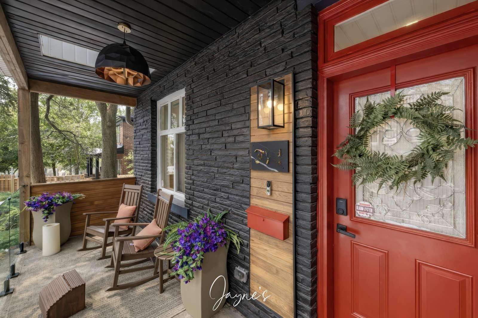 Cozy front porch with rocking chairs and vibrant red door