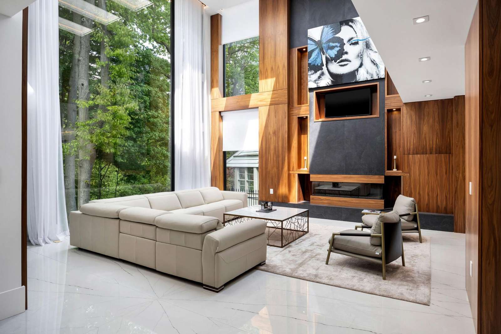 Spacious living room with floor-to-ceiling windows and cozy fireplace