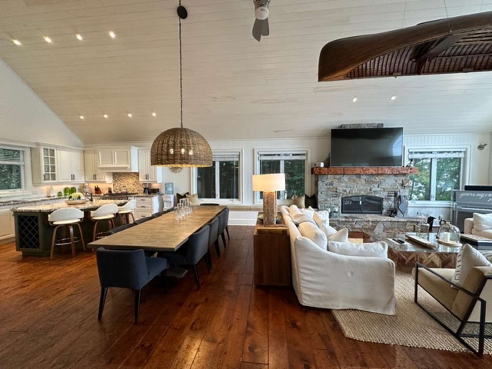 Spacious open-concept living and dining area with cozy fireplace