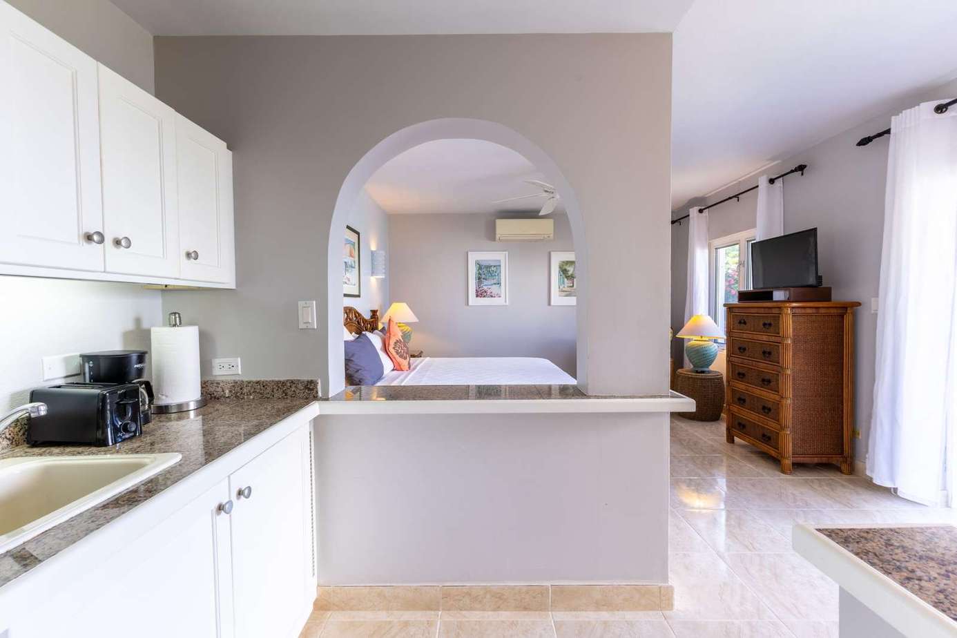 Bright kitchen with open view to cozy living room