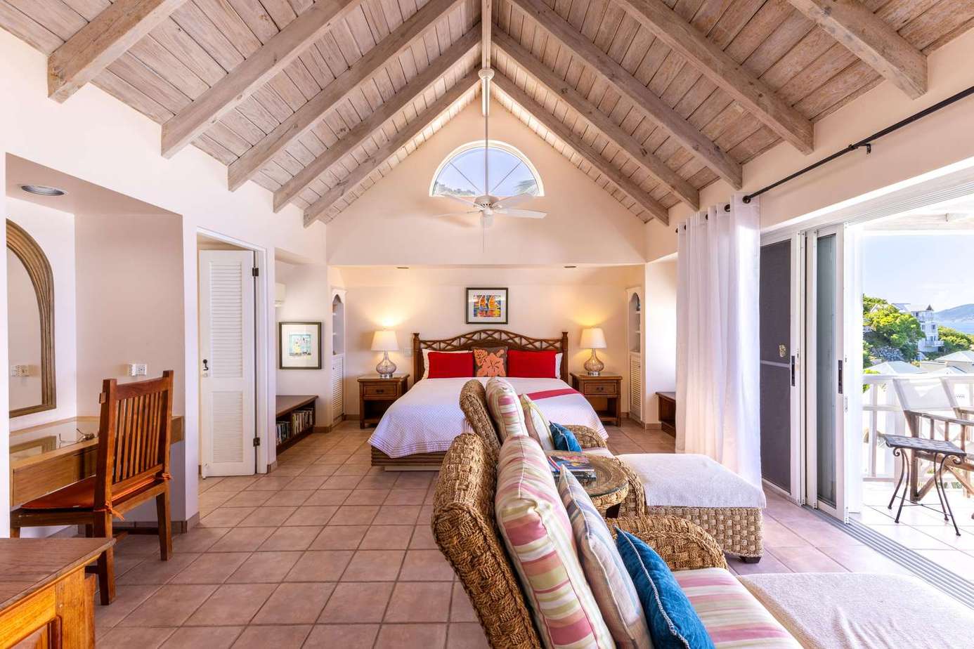 Sunlit bedroom retreat with vaulted ceilings and balcony views