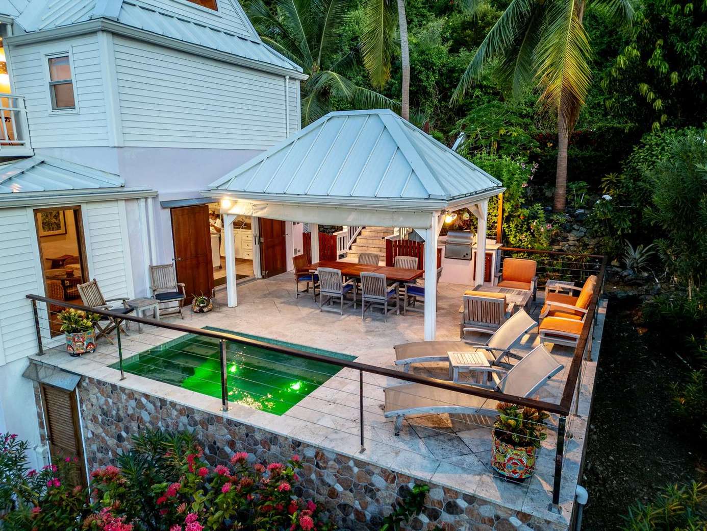 Secluded outdoor patio with pool and cozy seating area