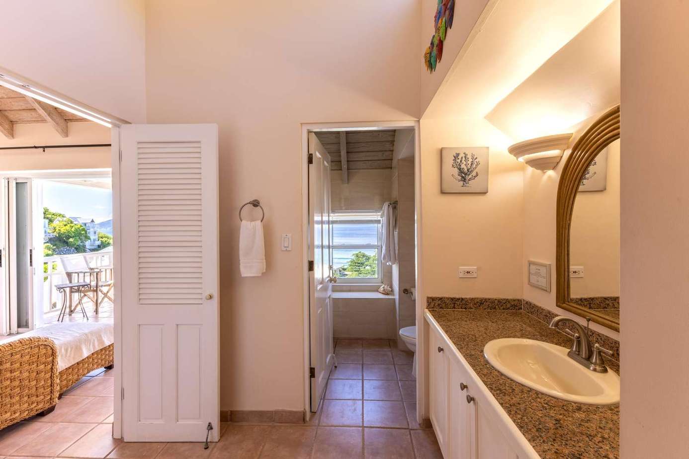 Bright, airy bathroom with granite countertop and natural light