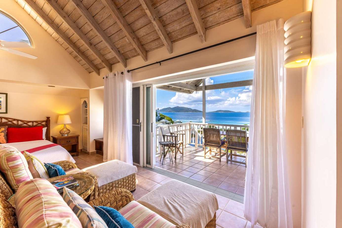 Cozy living room opening to a spacious ocean-view patio