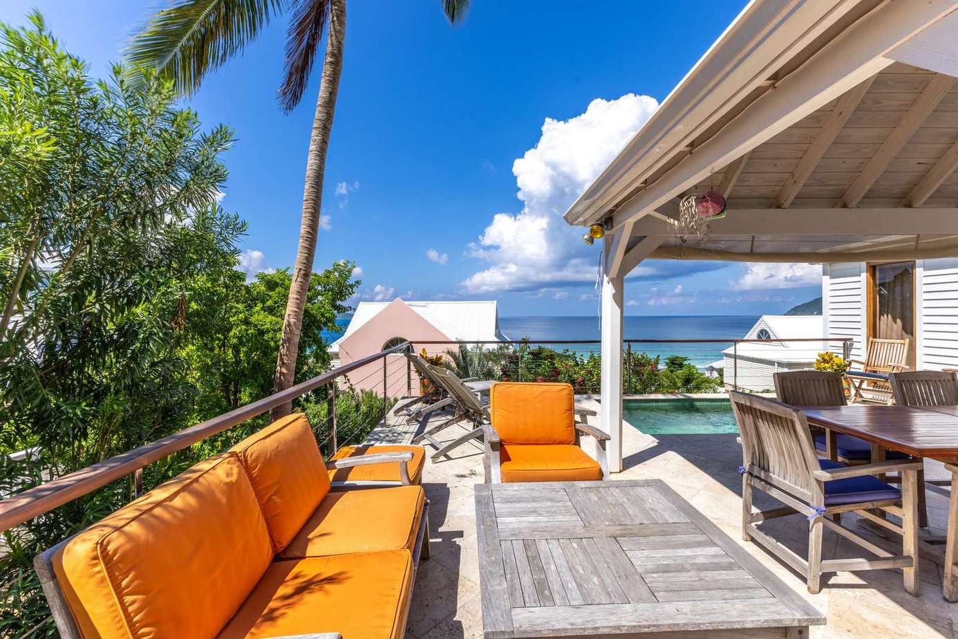 Sunlit patio with vibrant seating and ocean views