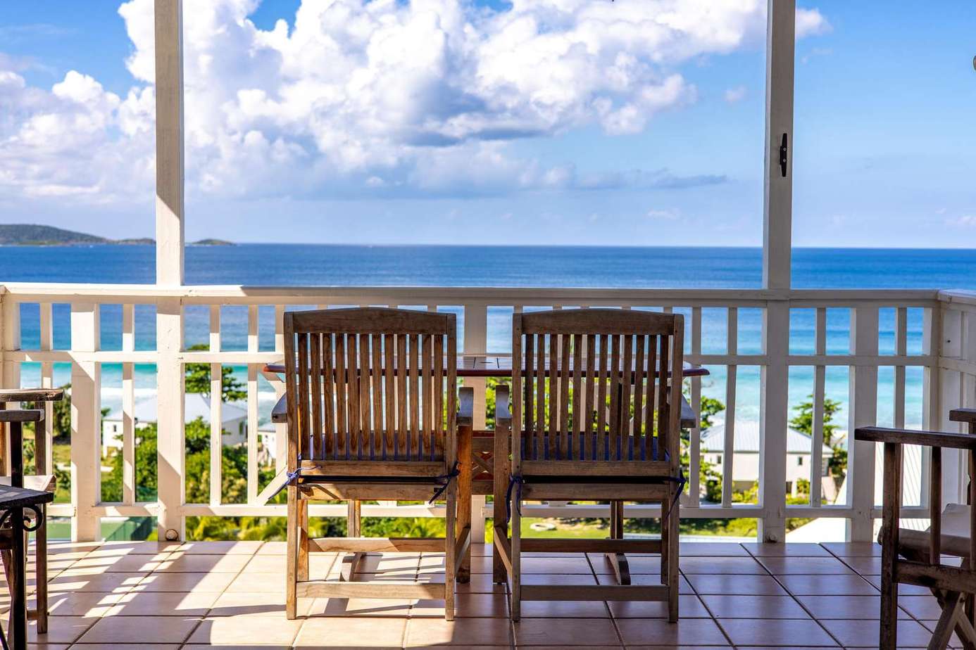 Oceanfront balcony with stunning panoramic views and cozy seating