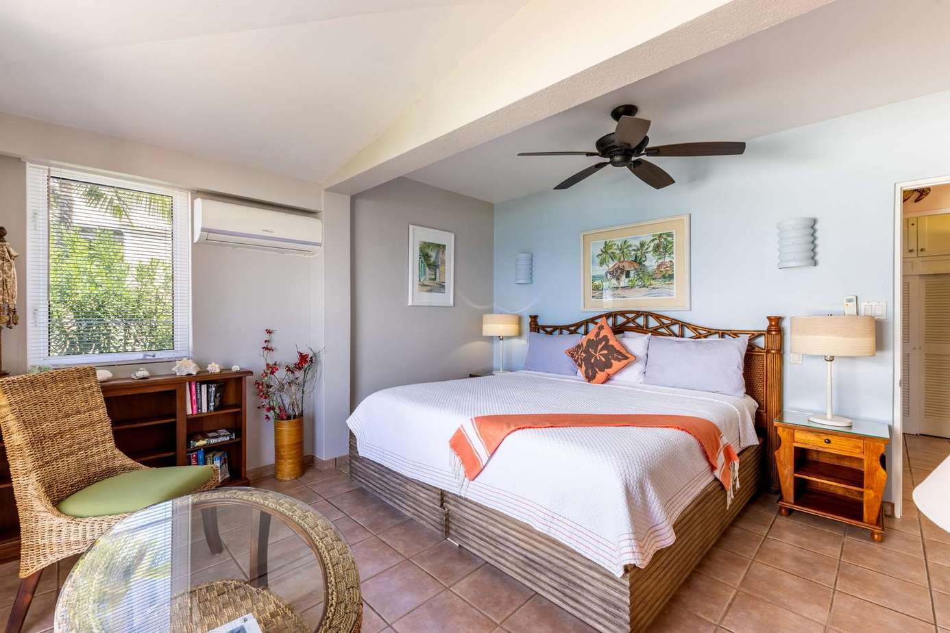 Bright and airy bedroom with cozy seating and workspace