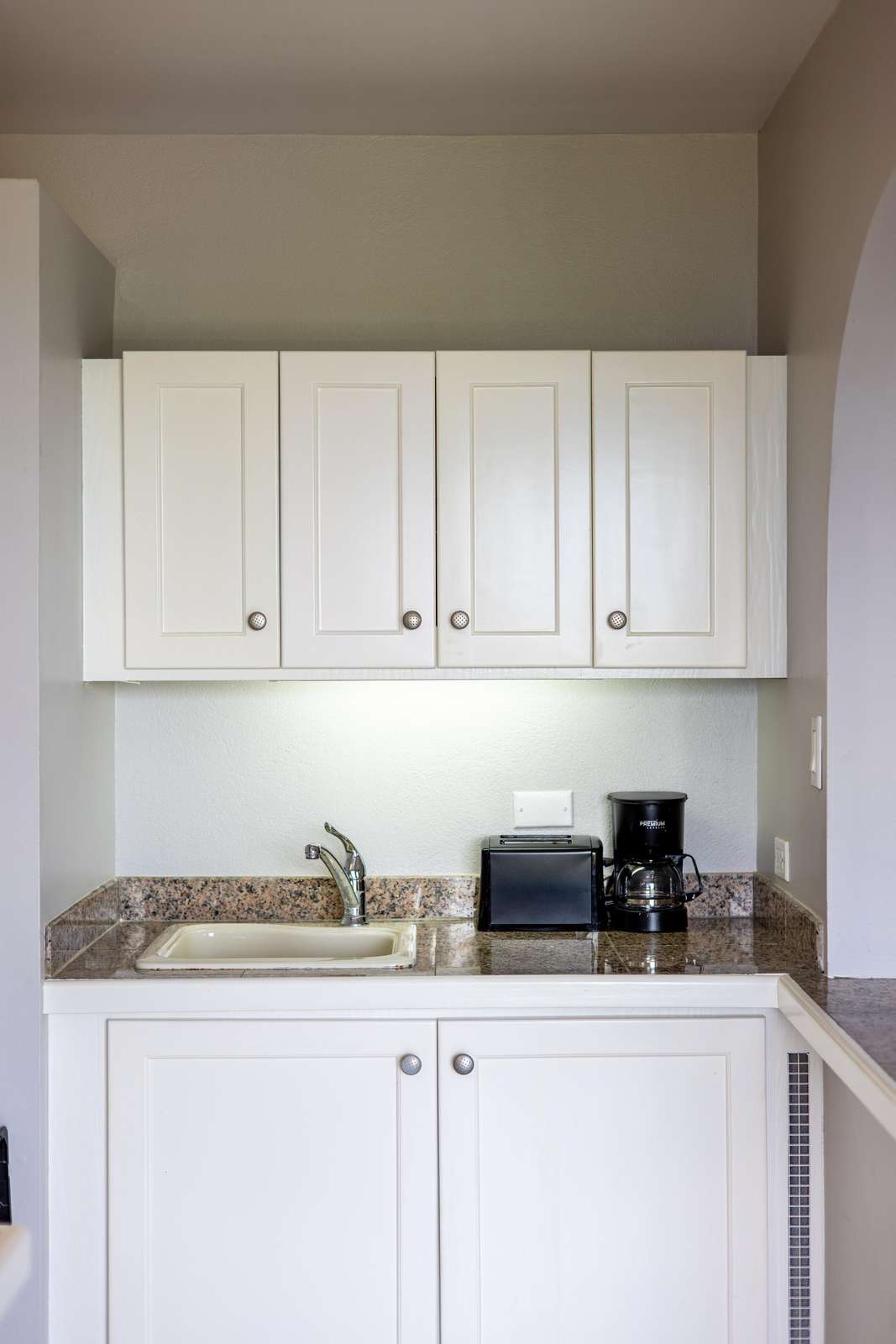 Cozy kitchenette with bright cabinetry and modern essentials