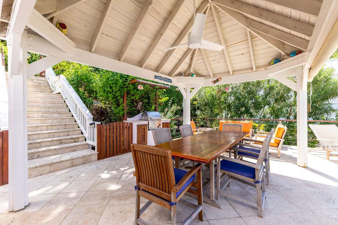 Shaded outdoor dining area surrounded by lush greenery