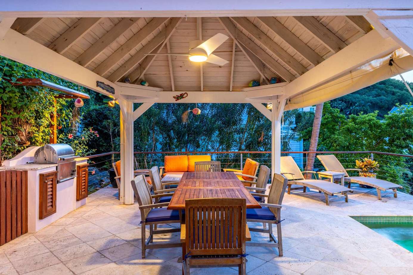 Spacious outdoor dining and lounge area under vaulted pavilion