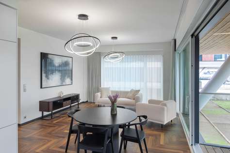 Bright dining area with modern lighting and garden views