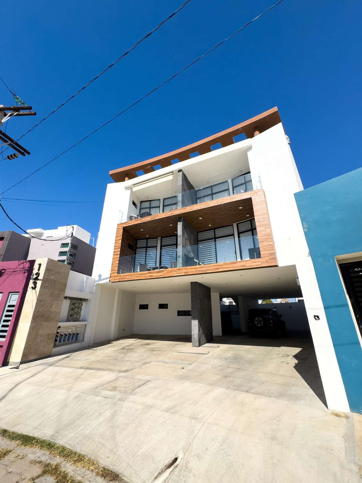 Modern three-story home with spacious balconies and parking - property
