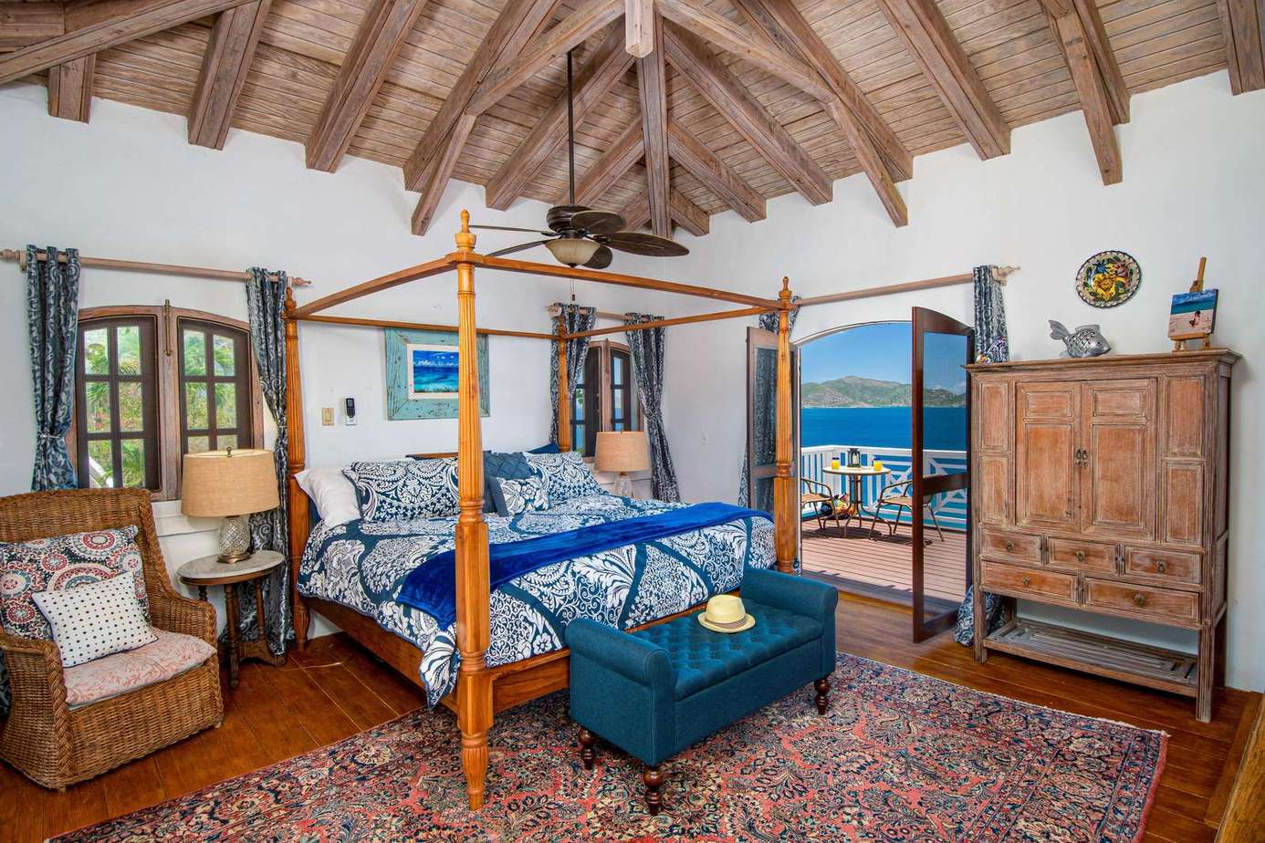 Cozy bedroom with vaulted ceilings and ocean views