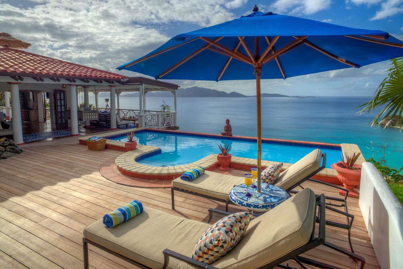 Sun-drenched patio with infinity pool and ocean views
