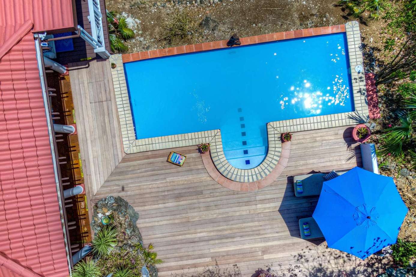 Sun-soaked pool deck with spacious lounging area