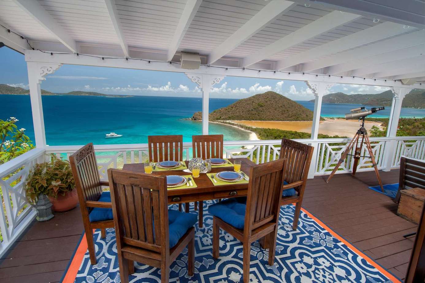 Oceanfront dining patio with panoramic sea views and cozy seating