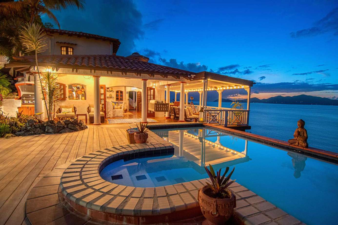 Waterfront patio with cozy fire pit and stunning sunset views