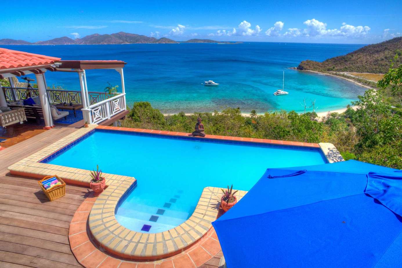 Oceanfront pool deck with panoramic bay views and lounge space