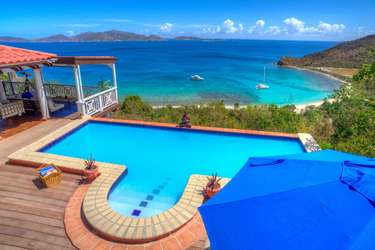 Oceanfront pool deck with panoramic bay views and lounge space