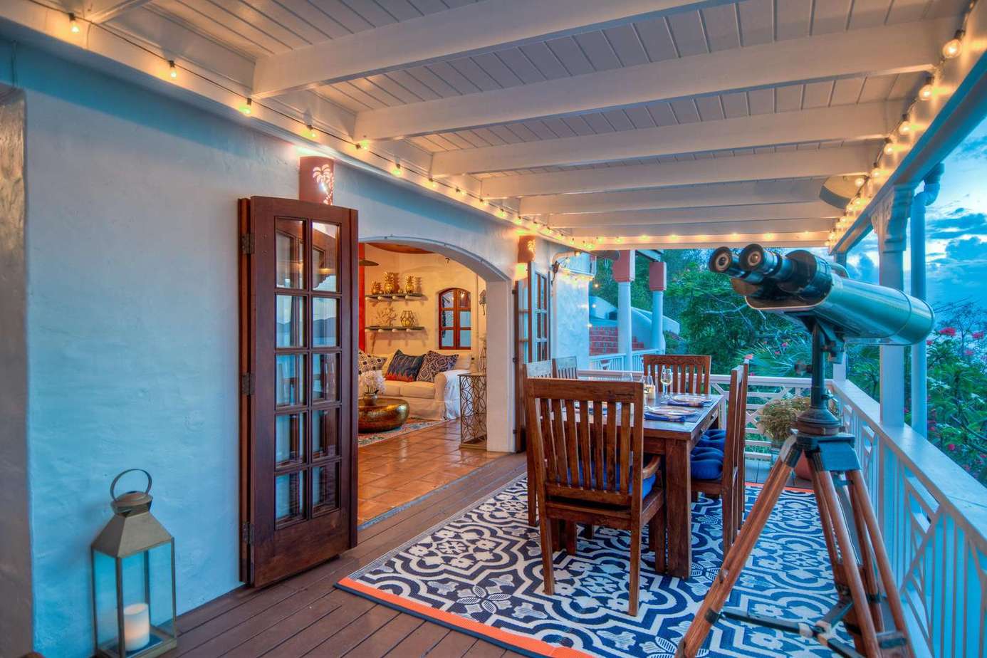 Cozy covered patio with charming string lights and mountain views