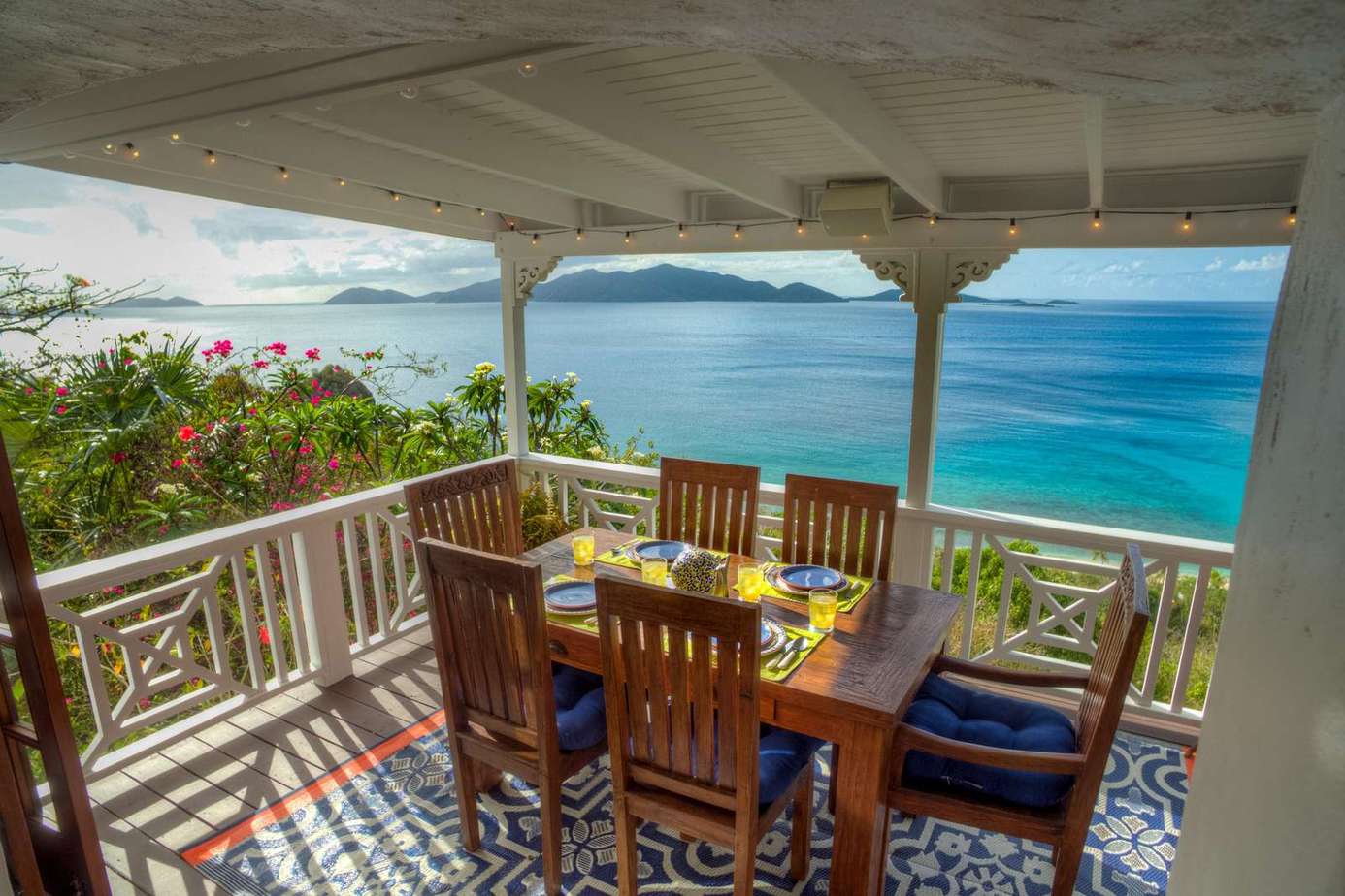 Oceanfront dining on a shaded veranda with stunning views