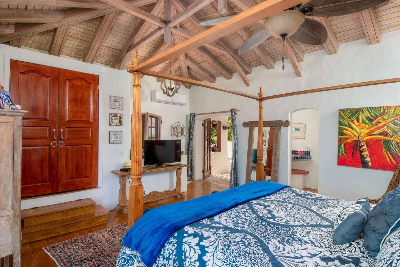 Cozy bedroom with rustic wooden beams and vibrant art