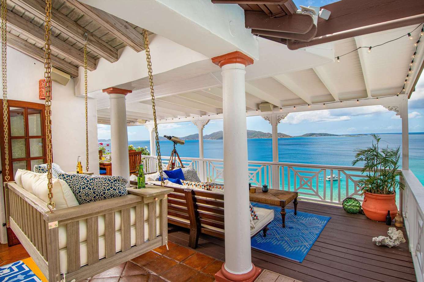 Oceanfront patio with cozy swing and panoramic views