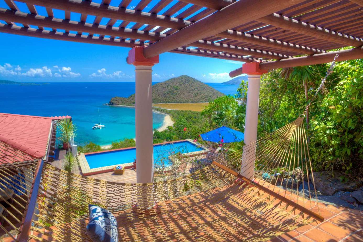 Ocean-view patio with shaded seating and infinity pool