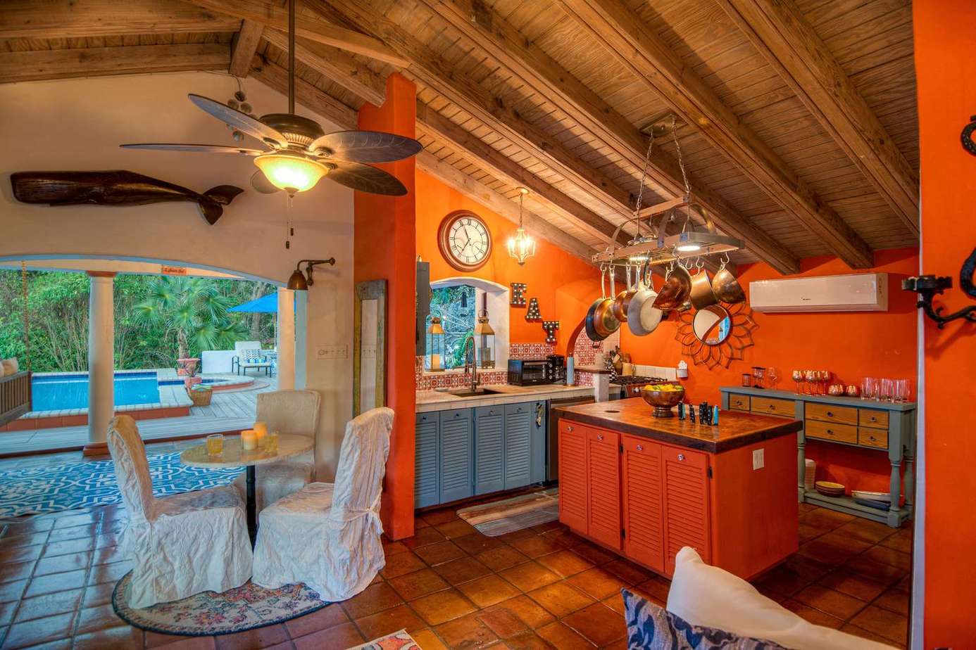 Vibrant kitchen and dining area with rustic charm and pool views