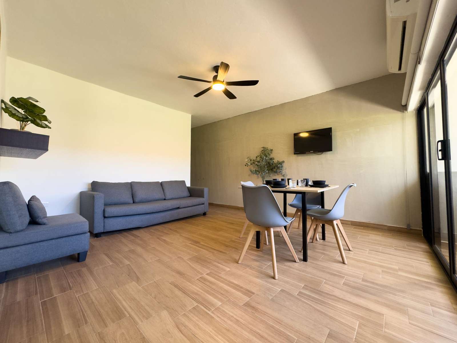 Spacious living room with modern seating and natural light - property