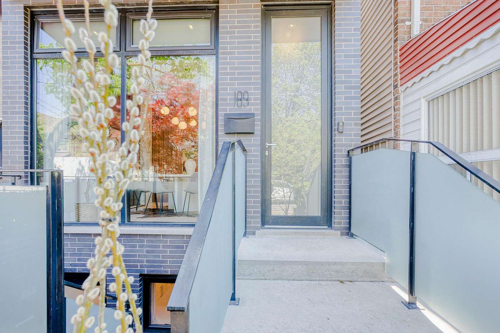 Bright, modern entryway with sleek glass railings and natural light