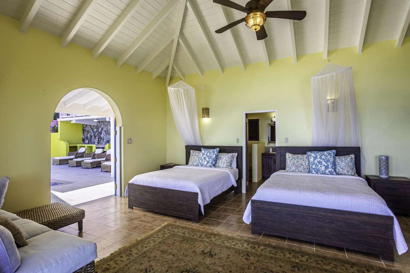Spacious bedroom with vaulted ceilings and garden views