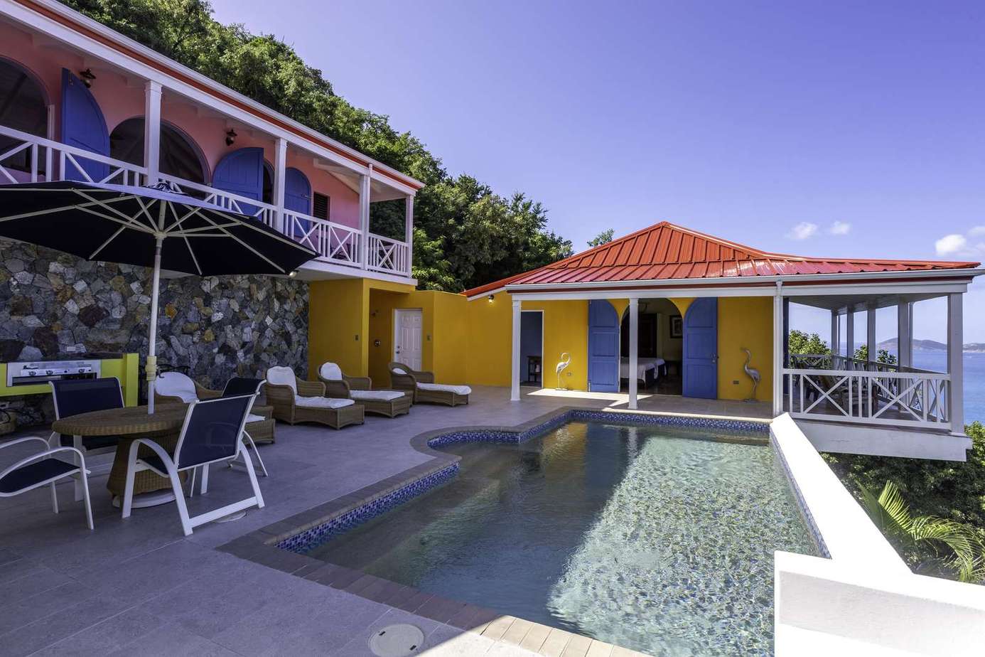 Sunlit poolside patio with vibrant tropical charm