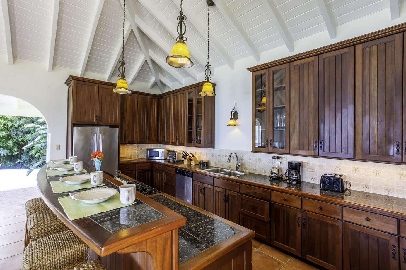 Spacious kitchen with rich wood cabinetry and vaulted ceilings