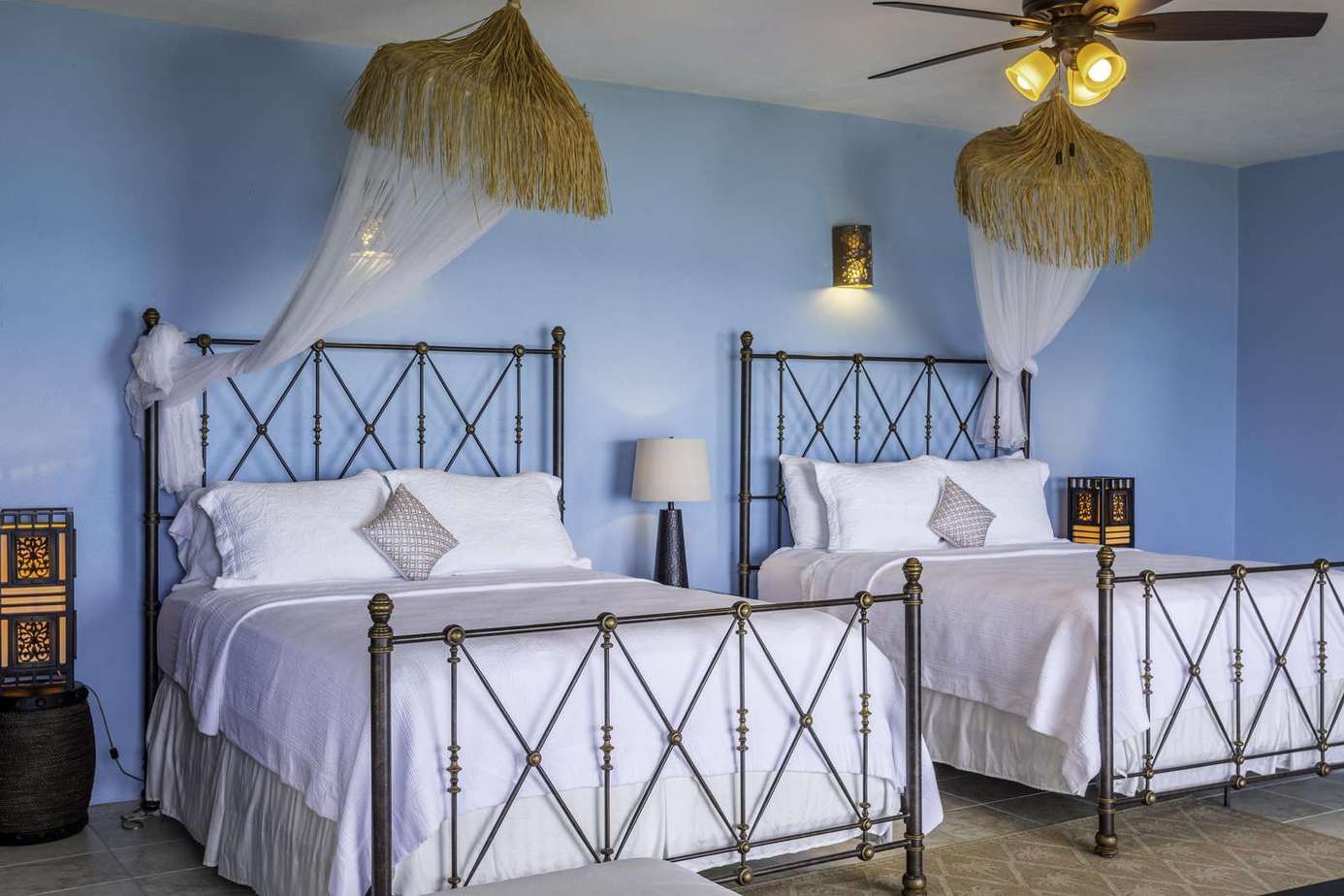 Spacious bedroom with elegant twin beds and cozy lighting