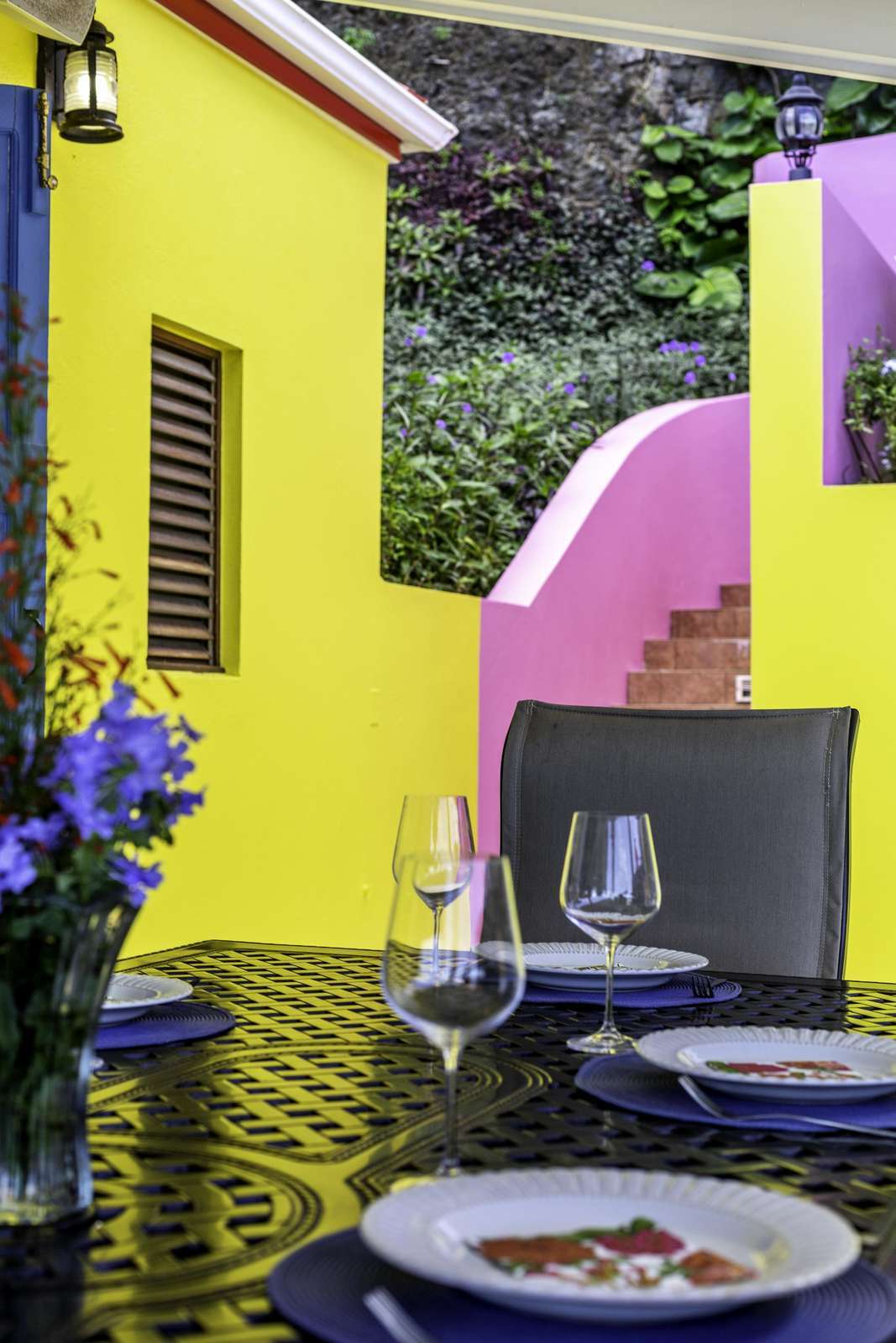 Vibrant outdoor patio with colorful walls and cozy seating