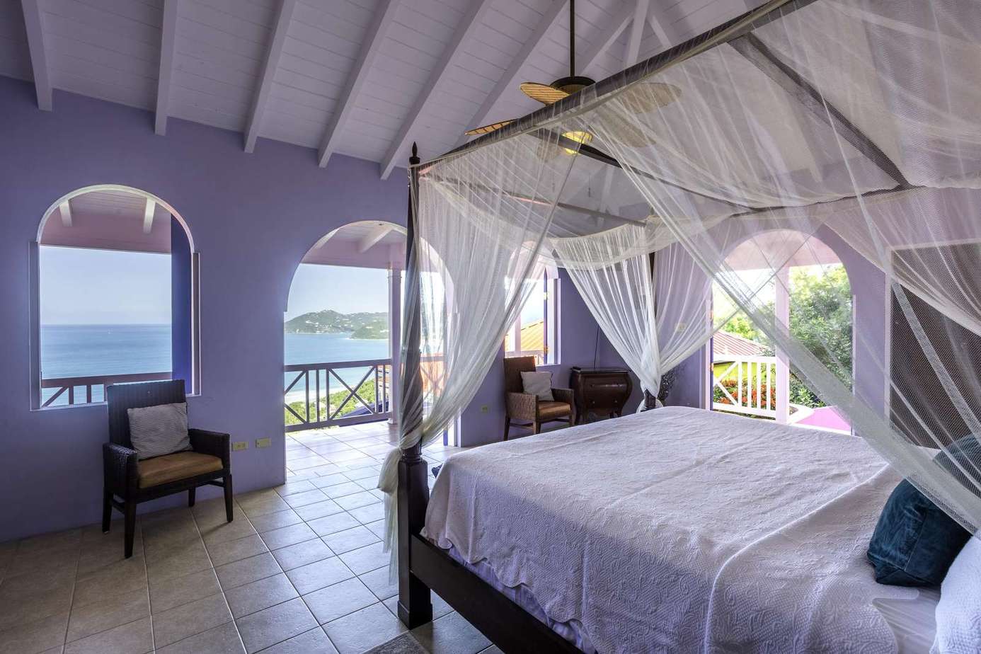 Airy bedroom with canopy bed and stunning ocean views