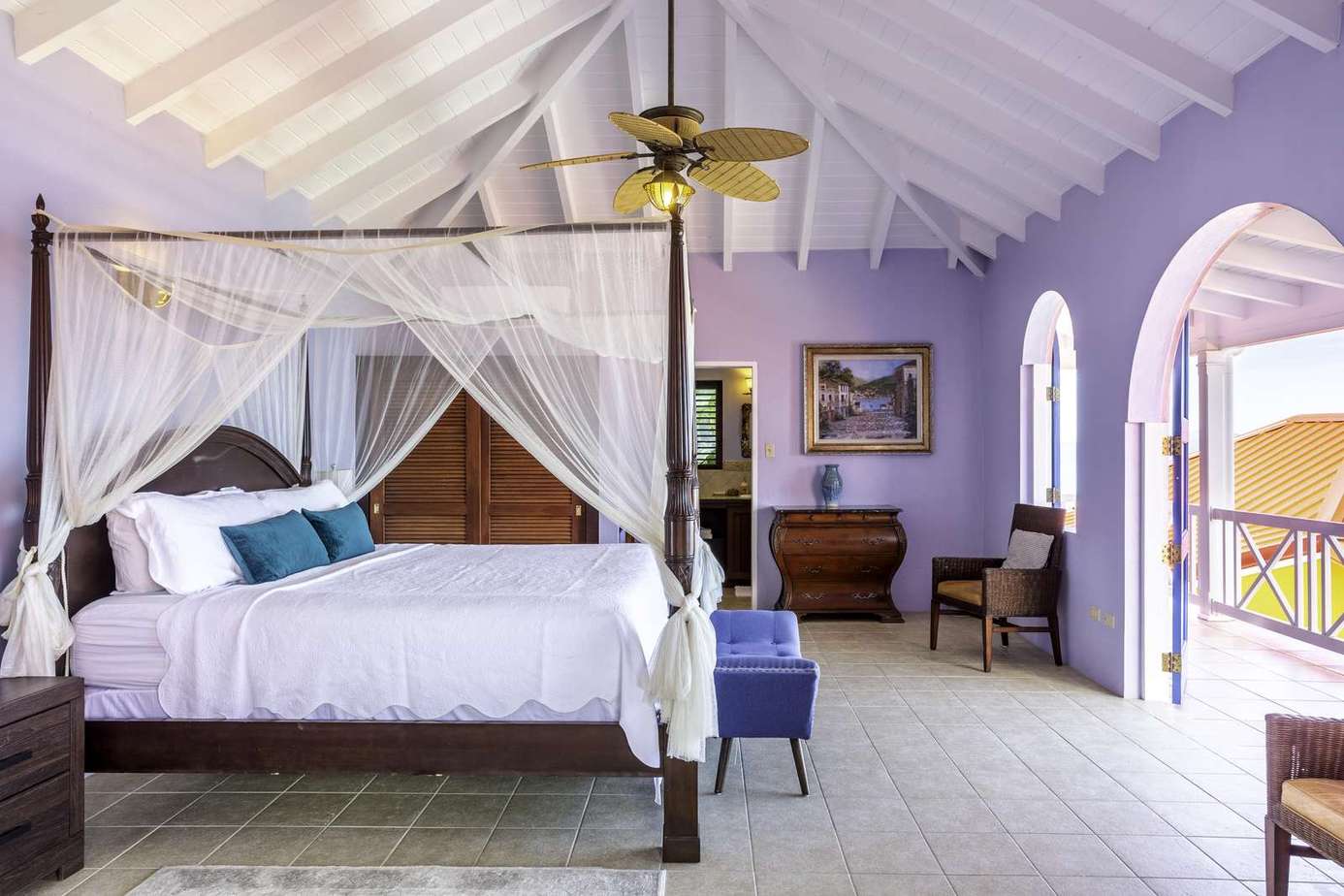 Airy bedroom with vaulted ceilings and balcony views