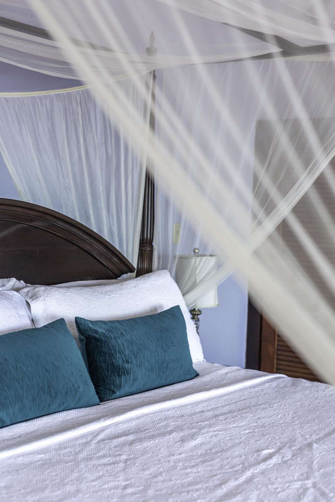 Cozy bedroom retreat with elegant canopy and plush pillows