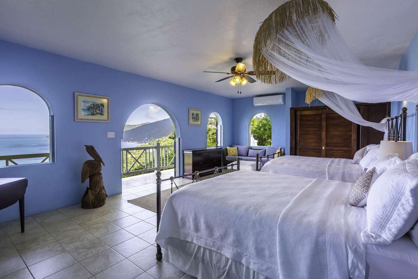 Serene bedroom with ocean views and airy blue walls