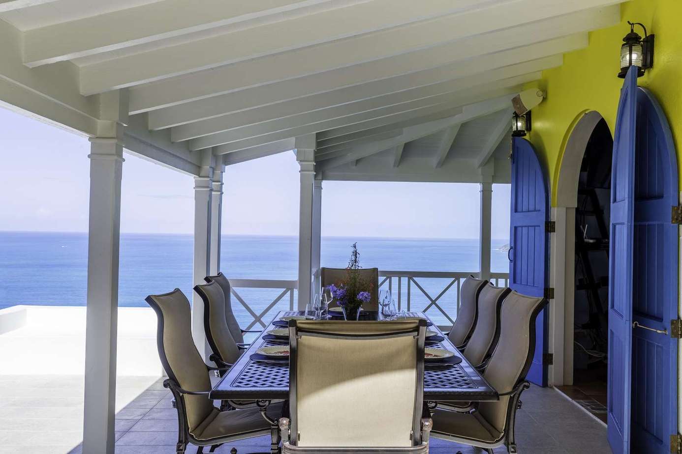 Oceanfront covered patio with spacious dining and stunning views