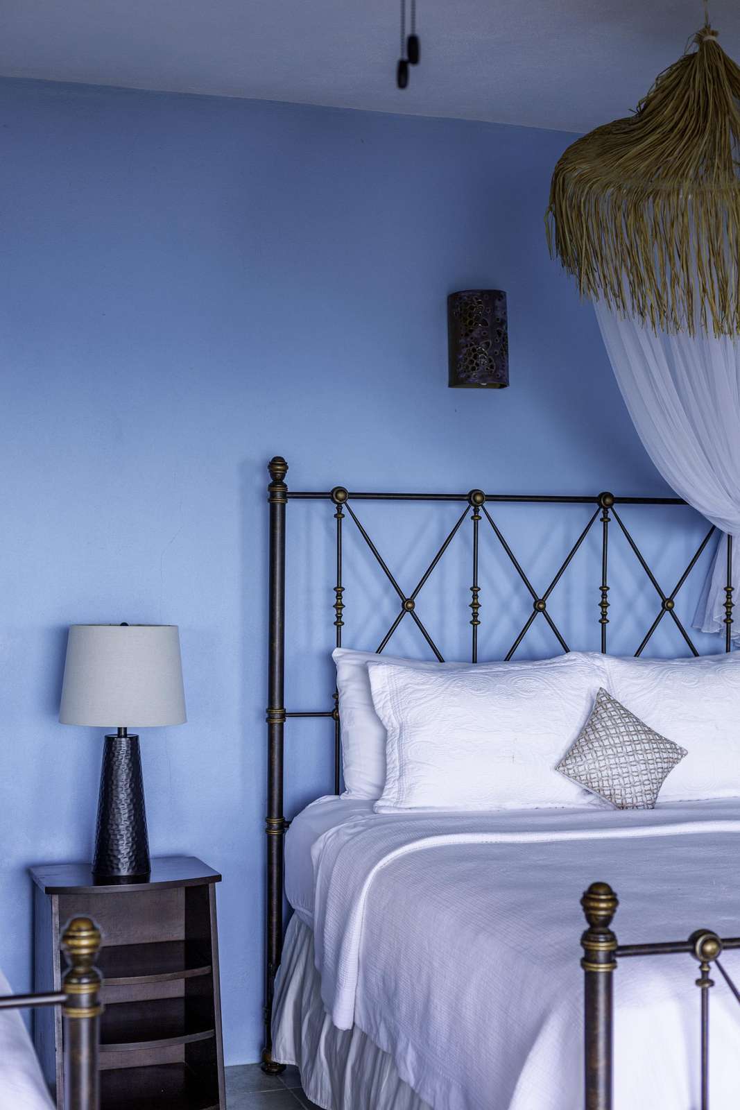 Cozy bedroom retreat with calming blue walls and soft lighting