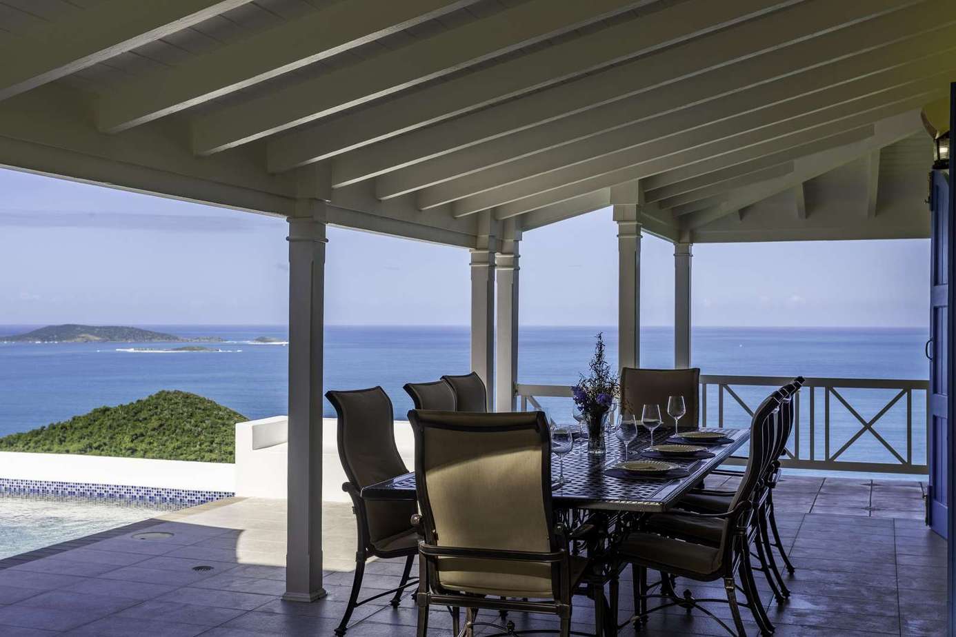 Covered patio with panoramic ocean views and dining area