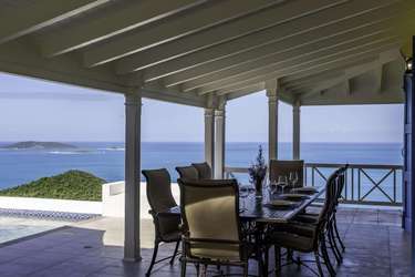 Covered patio with panoramic ocean views and dining area
