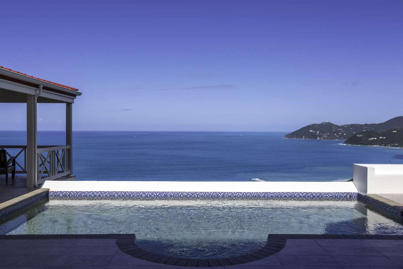 Infinity pool with panoramic ocean views and spacious deck